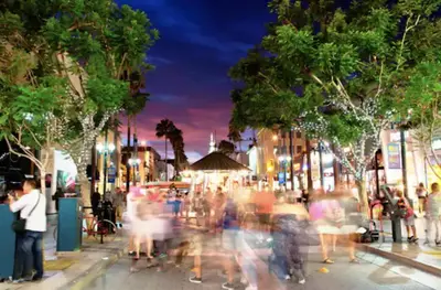 a crowd of people walking down a city street at night at Grand Studio On The Promenade Free Parking in Los Angeles