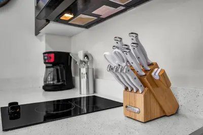a wooden block of knives sitting on a kitchen counter at Grand Studio On The Promenade Free Parking in Los Angeles