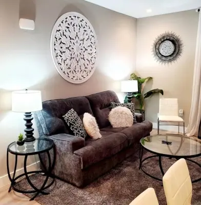 a living room with a brown couch and two tables at Spacious 2 bed 2 bath, Pool, Hottub, Wifi, 24 hr Fitness, Parking in Los Angeles