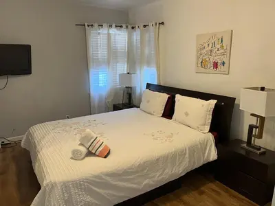 a bedroom with a bed with white sheets and pillows at Charming 1 bedroom apt in Beverly Hills in Los Angeles