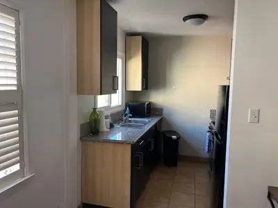 a small kitchen with a sink and a counter at Charming 1 bedroom apt in Beverly Hills in Los Angeles