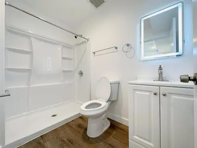 a white bathroom with a toilet and a shower at Eiven Homestay in Los Angeles