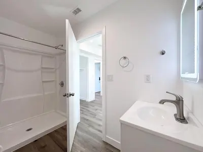 a white bathroom with a sink and a shower at Eiven Homestay in Los Angeles