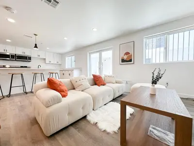 a white living room with a white couch and a table at The 1443 in Los Angeles