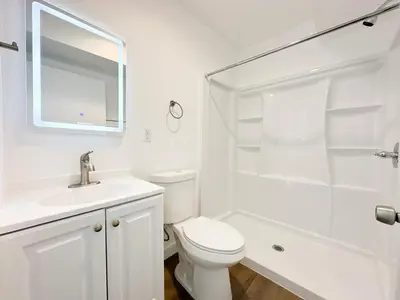 a white bathroom with a toilet sink and a shower at The 1443 in Los Angeles