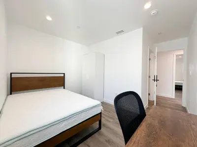 a bedroom with a bed and a chair in it at The 1443 in Los Angeles