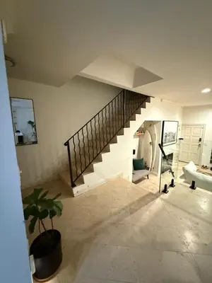 a hallway with a staircase in a house with a potted plant at Venice beach in Los Angeles