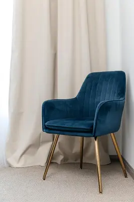 a blue chair sitting in front of a curtain at Brilliant 2BD condo in Los Angeles
