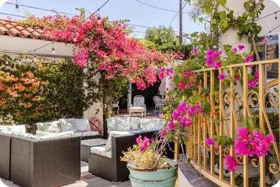 a garden with flowers in pots on a balcony at Zen guess house in Los Angeles
