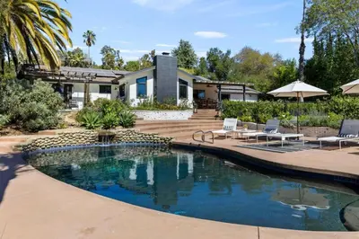 a house with a swimming pool in front of a house at Private Estate with Cottage, Pool & Tennis in Ojai