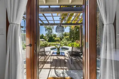 an open door to a patio with a table and chairs at Private Estate with Cottage, Pool & Tennis in Ojai