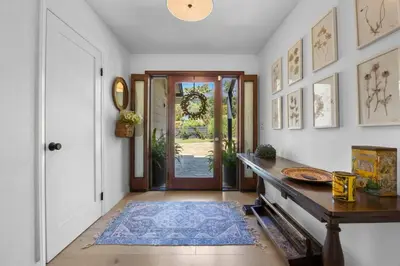 a hallway with a door and a table with a rug at Private Estate with Cottage, Pool & Tennis in Ojai