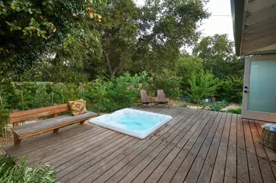 a wooden deck with a bench and a hot tub at Rancho Palomar in Ojai