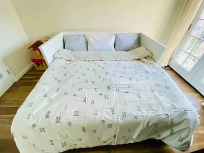 a bed with a white bedspread with music notes on it at Beach House in Los Angeles