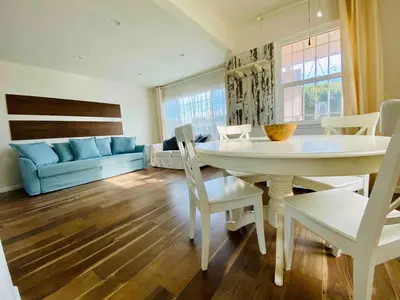 a living room with a table and chairs and a couch at Beach House in Los Angeles