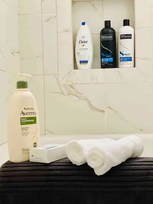 a bathroom with two rolls of toilet paper and two bottles of soap at Beach House in Los Angeles