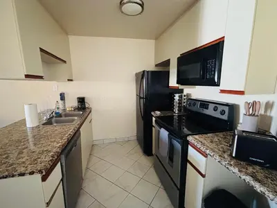 a kitchen with a black refrigerator and a sink at 1Bd Prime Westwood Location One Block from UCLA in Los Angeles