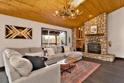 a living room with a couch and a fireplace at Cielos Nest Cabin | Close to Village and Lake with Hot Tub in Big Bear Lake