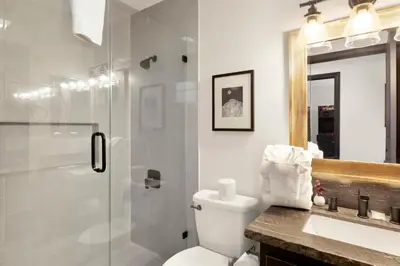 a bathroom with a shower and a toilet and a sink at Cielos Nest Cabin | Close to Village and Lake with Hot Tub in Big Bear Lake