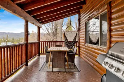 a porch with a hammock and a table and chairs at Cielos Nest Cabin | Close to Village and Lake with Hot Tub in Big Bear Lake
