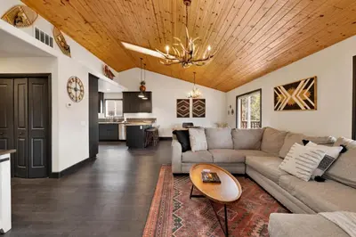 a living room with a couch and a table at Cielos Nest Cabin | Close to Village and Lake with Hot Tub in Big Bear Lake