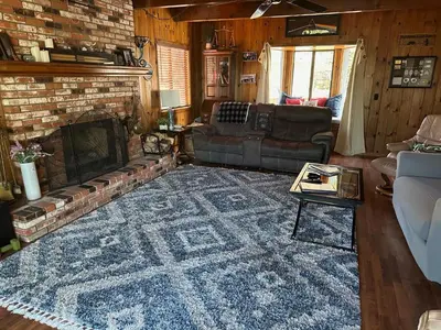 a living room with a couch and a fireplace at Le Studio de Sud in Lake Arrowhead