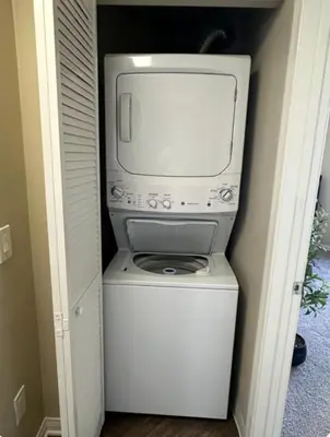 a microwave sitting on top of a washer and dryer at Spacious 1B 1B Pool View Loft Apartment in Marina Del Rey in Los Angeles