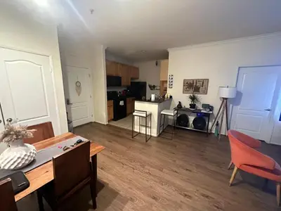 a large living room with a table and a kitchen at Spacious 1B 1B Pool View Loft Apartment in Marina Del Rey in Los Angeles