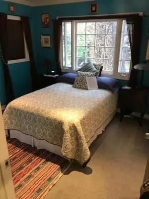 a bedroom with a bed and a large window at Elaine's Hollywood Bed & Breakfast in Los Angeles