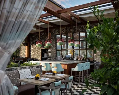 a restaurant with tables and chairs and a bar at Dream Hollywood, by Hyatt in Los Angeles