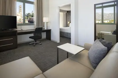 a hotel room with a couch and a desk and a bed at Residence Inn by Marriott Los Angeles Pasadena/Old Town in Pasadena