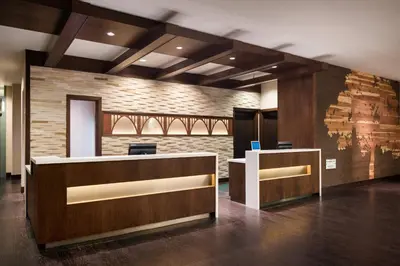 an office with a reception desk and a brick wall at Residence Inn by Marriott Los Angeles Pasadena/Old Town in Pasadena