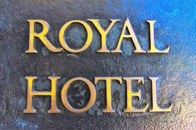 a close up of a metal sign that reads royal iron at Hotel Royal in Long Beach