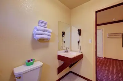 a bathroom with a sink and a toilet and towels at Welcome Inn in Inglewood