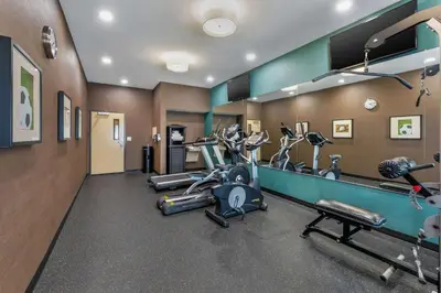 a gym with several treadmills and elliptical machines at Best Western Plus Taft Inn in Taft