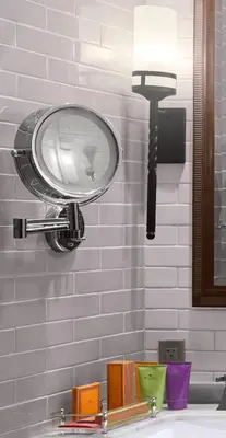 a bathroom sink with a light on the wall at Plaza la Reina in Los Angeles