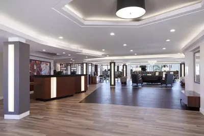 a large lobby with a reception desk and tables at Fairfield Inn & Suites By Marriott Camarillo in Camarillo