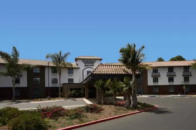 a view of the front of a hotel with palm trees at Fairfield Inn & Suites By Marriott Camarillo in Camarillo