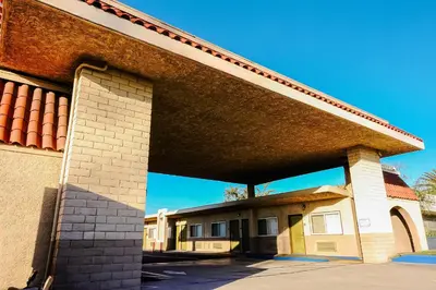 a large brick building with a roof at Tropic Lodge in Anaheim