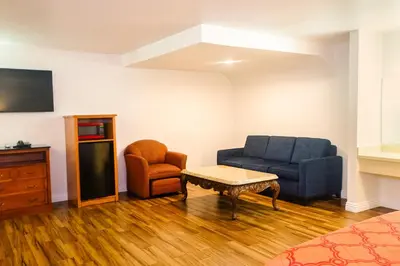a living room with a couch and a chair at Tropic Lodge in Anaheim