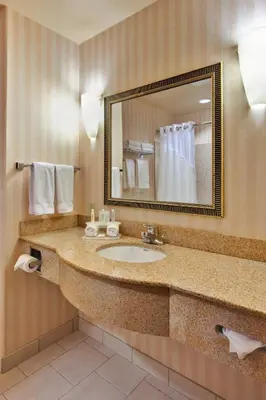 a hotel bathroom with a sink and a mirror at Holiday Inn Express Delano Highway 99 by IHG in Delano