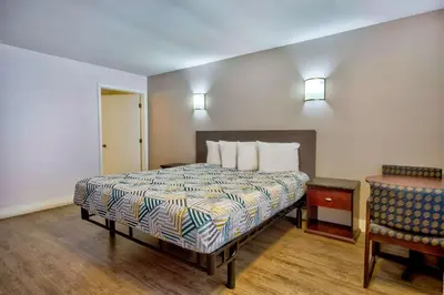 a hotel room with a bed and a chair at Motel 6-Inglewood, CA in Inglewood