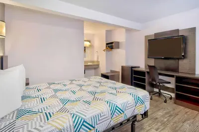 a hotel room with a bed and a desk at Motel 6-Inglewood, CA in Inglewood