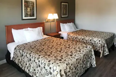 a hotel room with two beds and two lamps at Rodeway Inn Ontario Mills Mall in Guasti