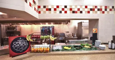 a kitchen with a counter with vegetables and fruits at Embassy Suites Palmdale in Palmdale