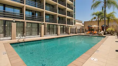 a large swimming pool in front of a building at Holiday Inn Express Fullerton-Anaheim by IHG in Fullerton