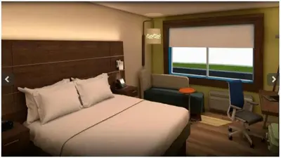 a bedroom with a bed and a chair and a window at Holiday Inn Express Fullerton-Anaheim by IHG in Fullerton
