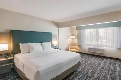a hotel room with a large bed and a window at Hourglass Hotel, Trademark Collection by Wyndham in Bakersfield