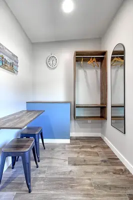 a dining room with a table and two stools at White Caps Motel in Ventura
