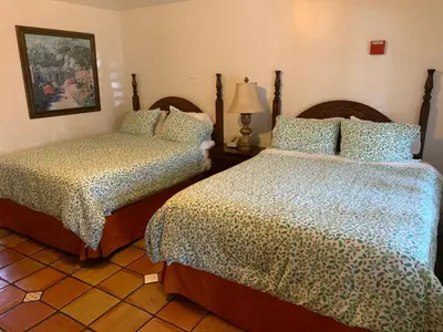 a bedroom with two beds and a lamp at Chantico Inn in Ojai